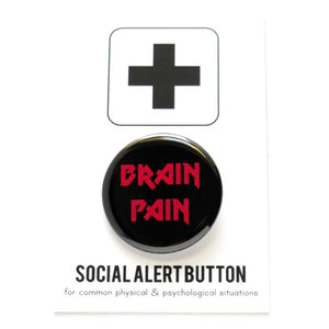 Round pinback button that says BRAIN PAIN. Red text on a black background.