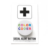 Round pinback button that reads COLOR CODER. Mulit-colored text on a white background. Button is attached to Social Alert Button Backing card with a black plus sign at the top.
