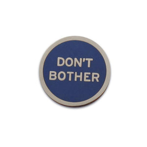 Round enamel pin that says DON'T BOTHER.  Silver text and outline on a navy blue background