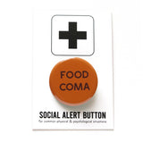 Round brow-orange pinback button that reads FOOD COMA in dark brown san serif text. The button is pinned to a Social Alert Button backing card.