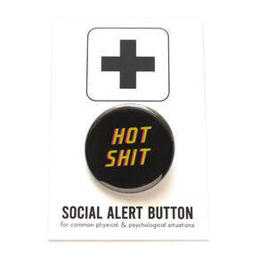 Round black pinback button that reads HOT SHIT in neon yellow with a hot pink drop shadow. Button is on a Social Alert Button backing card.