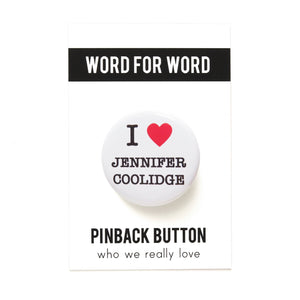 A round white button that reads I LOVE JENNIFER COOLIDGE, love being represented by a red heart. Button is on a Word For Word backing card that reads Pinback Button, Who We Really Love at the bottom