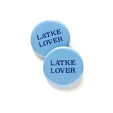 Two light blue round pinback buttons that read LATKE LOVER in a dark blue serif font.  