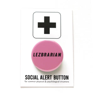 Round pink colored pinback button which reads LEZBRARIAN in a black italic sans serif font. The button is on a white Social Alert Button backing card with a black plus sign at the top.
