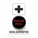 Round pinback button that says MIGRAINE BRAIN. Red text on a black background.