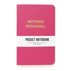 Bold pink pocket notebook that says NOTHING PERSONAL in gold  text.