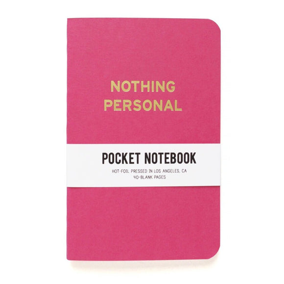 Bold pink pocket notebook that says NOTHING PERSONAL in gold  text.