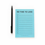 Light blue 4x6" inch notepad. Reads NO TIME TO LOSE at the top in a black sans serif font. Eleven check boxes line the left side of the page, with lines to write your task on the write. Small text listing word for word factory's website www.wordforwordfactory.com at the bottom.