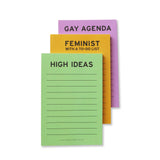 3 small notepads in the same style in different colors, stacked on top of each other. The top notepad is mint green and reads HIGH IDEAS, with lines to write below the title. The second notepad is goldenrod yellow and reads FEMINIST WITH A TO-DO LIST at the top, and the third notepad is Lavender and reads GAY AGENDA at the top.