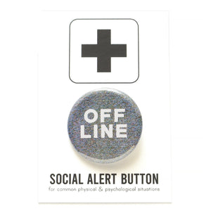 Product photo of a 1.25" round pinback button on as social alert cardboard backing card.  The background is a pattern of pixelated digital noise and the text says OFF LINE in white letters