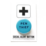 bright blue round pinback button that reads PEN THIEF in a dark blue san serif font. Button is on a Social Alert Backing card