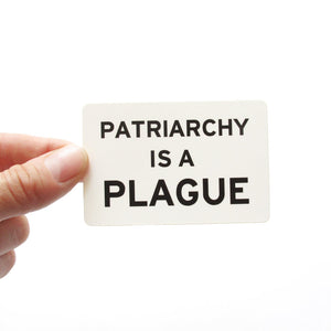 Rectangle sticker that says PATRIARCHY IS A PLAGUE.  Black text on a white background.