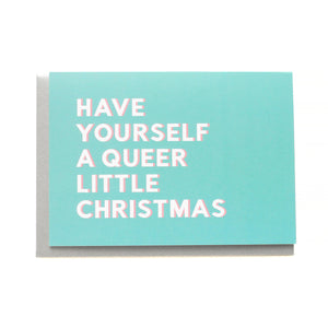 Holiday greeting cards that say HAVE YOURSELF A QUEER LITTLE CHRISTMAS.  White text on a icy blue background.