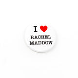 Round white pinback button that reads I LOVE RACHEL MADDOW, with love being represented by a red heart. 