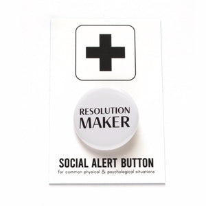 Shiny white pinback button which read RESOLUTION MAKER in black text