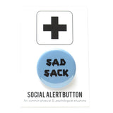 Round pinback button that says SAD SACK.  Black text on a light blue background.