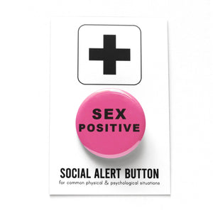 Round medium pink pinback button that reads SEX POSITIVE in a thick black san serif font. Pinback button is on Social Alert Button Backing Card