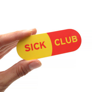 Capsule shaped sticker that says SICK CLUB.  The background is like a yellow and red capsule pill.