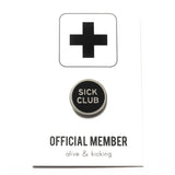 Round enamel pin that says SICK CLUB on a backing card that says Official Member.