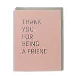 Dusty rose A2 vertical greeting card with a gray envelope. In a thin sans serif font in silver foil the card reads THANK YOU FOR BEING A FRIEND, from Golden Girls TV Show