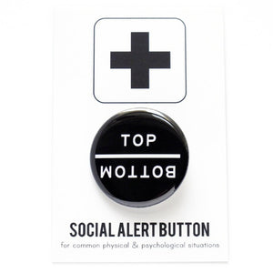 Round pinback button that says TOP and directly underneath it, upside down, its says BOTTOM.  White text on a black background.  The button is pinned to a Social Alert Button backing card.
