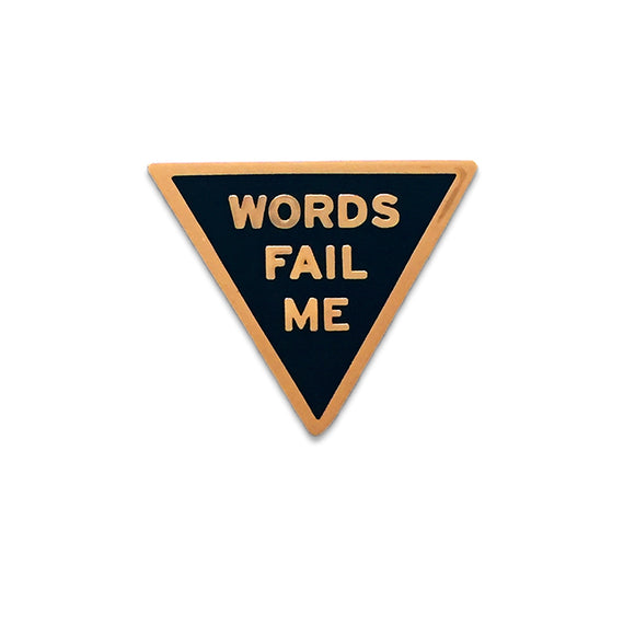 Triangle shaped hard enamel pin that says WORD FAIL ME.  Rosegold text and outline on a black enamel background.