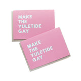 Holiday greeting cards that say MAKE THE YULETIDE GAY .  Whit text on a pink background.
