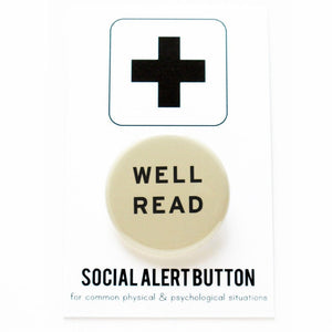Round pinback button that says WELL READ. Black text on a cream background.